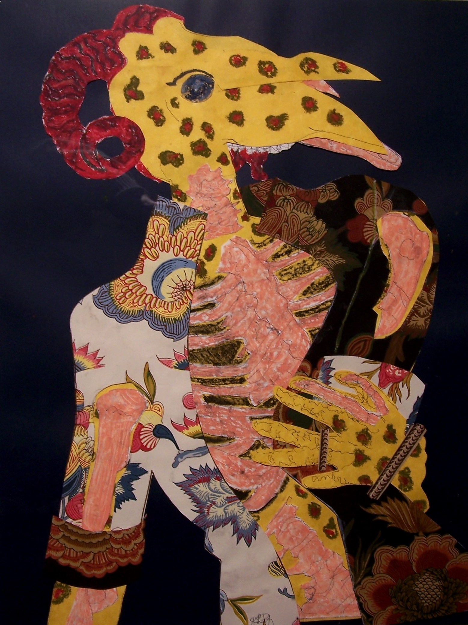 This collage features an animal made out of a variety of different animals. The head is a bird-like with double beaks and rams horns. The torso and arms are humanoid with a six-fingered bird hand. It is wearing a jacket out of flower-patterned paper, the left side a white background and right side, black background, giving a sense of illumination. The jacket is open revealing pink ribs and intestines and the pink is repeated in shapes around the beak, arm and lower torso. The creature’s flesh is yellow with spots consisting of red dots surrounded by brown. There is blood dripping from its mouth.