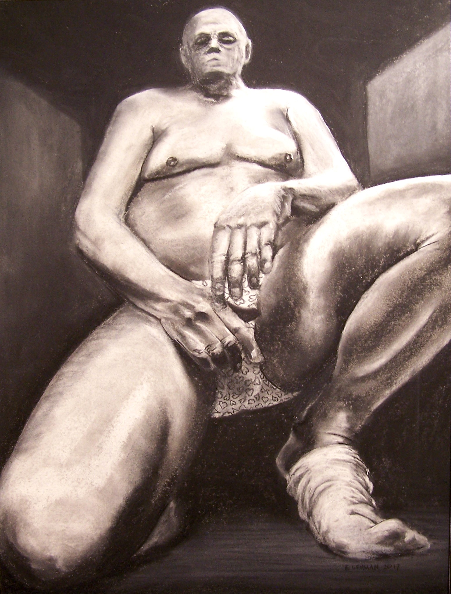 A charcoal drawing of a bald man. The figure is kneeling on his right knee with his left foot on the ground, elevated by the ball of his foot. His legs are much closer to the viewer and his head moves back into diminishing perspective. The head is smaller than is realistic, enhancing the perspective.  He is resting his arms on his thighs and is nude except for underwear that has hearts on them. The hands cover most of his underware. The only other clothing he is wearing is a sock that is coming off of his left foot. 